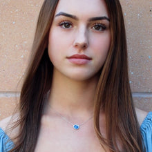 Load image into Gallery viewer, Bright blue lapis lazuli single stone necklace on young lady with brown hair in front of a stone wall

